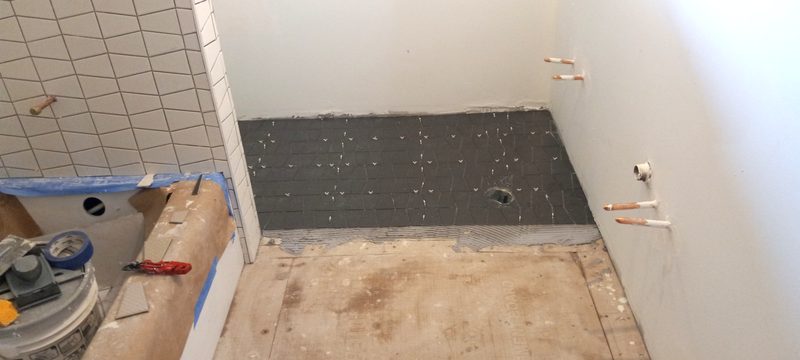 Bathroom tile installation in progress