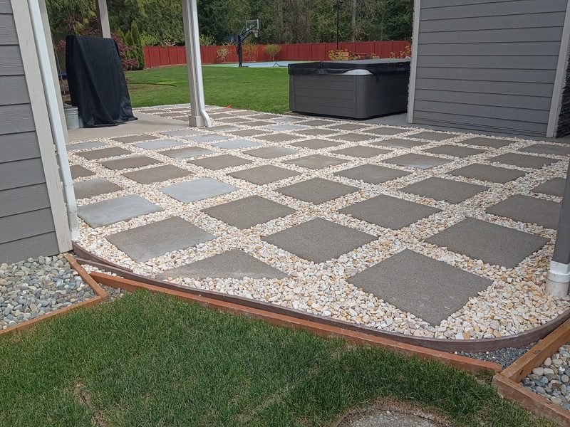 Gorgeous paver patio with stone pattern, hot tub, and green lawn